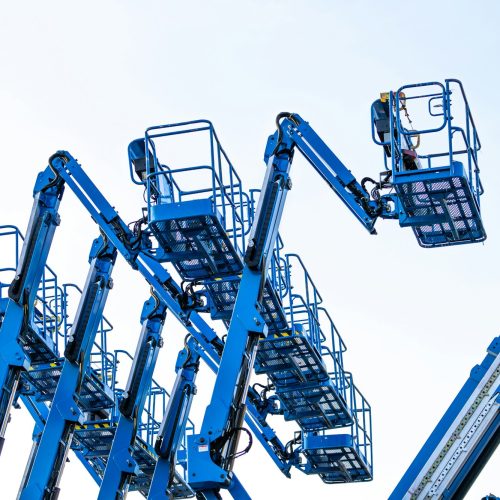 Articulated boom lift. Aerial platform lift. Telescopic boom lift against clear sky. Mobile crane